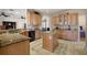 Spacious kitchen featuring wood cabinets, granite countertops, and a center island at 6813 S Fork Ranch Dr, Clermont, FL 34714