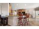 Open-concept kitchen features granite countertops, custom cabinets, and a breakfast bar at 6813 S Fork Ranch Dr, Clermont, FL 34714