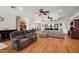 Spacious living room with wood floors, neutral sofas, and open layout to other areas at 6813 S Fork Ranch Dr, Clermont, FL 34714