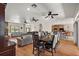 Open-concept living area offering wood floors, fireplace view, and connections to kitchen and dining at 6813 S Fork Ranch Dr, Clermont, FL 34714