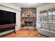 Living room with stone fireplace, mounted television and a view to the outdoors at 6813 S Fork Ranch Dr, Clermont, FL 34714