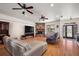 Inviting living room with a cozy stone fireplace and hardwood floors, perfect for relaxation at 6813 S Fork Ranch Dr, Clermont, FL 34714
