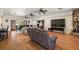 Expansive living area with hardwood floors, view of fireplace, and access to the dining space at 6813 S Fork Ranch Dr, Clermont, FL 34714