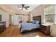 Main bedroom with ceiling fan, hardwood floors, barn door and lots of natural light at 6813 S Fork Ranch Dr, Clermont, FL 34714