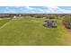 Overhead view of open field with pond and livestock roaming around at 6813 S Fork Ranch Dr, Clermont, FL 34714