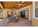 Covered patio with stone floor, wood ceiling, and comfortable seating and dining area at 6813 S Fork Ranch Dr, Clermont, FL 34714