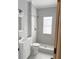 Clean and modern bathroom with white tiled shower, modern fixtures, and white vanity at 728 Mckenzie St, Leesburg, FL 34748