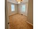 Bedroom featuring tan carpet, neutral paint, and a window with blinds and ceiling fan at 728 Mckenzie St, Leesburg, FL 34748