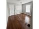 Bright bedroom with wood floors and two windows at 728 Mckenzie St, Leesburg, FL 34748