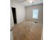 Bedroom featuring tan carpet, neutral paint, closet, and a window with blinds at 728 Mckenzie St, Leesburg, FL 34748