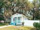 Charming single story home featuring a covered front porch, light blue paint and sidewalk with grass on either side at 728 Mckenzie St, Leesburg, FL 34748