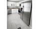Bright kitchen with white cabinets, stainless steel appliances, and granite countertops at 728 Mckenzie St, Leesburg, FL 34748