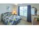 Cozy bedroom with a large window providing natural light and a comfortable-looking bed at 773 Artesia Ave, The Villages, FL 32162