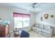 Functional den or office space with sofa, large window and a ceiling fan for added comfort at 773 Artesia Ave, The Villages, FL 32162