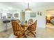 A dining area with a wooden table and chairs is adjacent to a modern kitchen at 773 Artesia Ave, The Villages, FL 32162