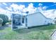 Home exterior featuring a screened lanai and well-maintained lawn at 773 Artesia Ave, The Villages, FL 32162