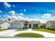 Charming single-story home boasts a well-manicured lawn, inviting curb appeal, and an attached garage at 773 Artesia Ave, The Villages, FL 32162