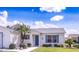 A close up of the entrance to a one-story home featuring blue shutters and a small palm tree at 773 Artesia Ave, The Villages, FL 32162