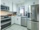 A kitchen with white cabinetry and stainless appliances is a great place to prepare a meal at 773 Artesia Ave, The Villages, FL 32162