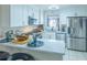 Well-lit kitchen with stainless steel appliances and breakfast bar at 773 Artesia Ave, The Villages, FL 32162