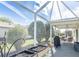 Screened lanai with an outdoor dining setup and view of the landscaped backyard at 773 Artesia Ave, The Villages, FL 32162