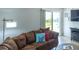 A modern sofa in a bright room features a slider to the patio and is perfect for entertaining at 773 Artesia Ave, The Villages, FL 32162