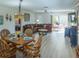 A comfortably furnished living room includes a dining area, a large sectional, and sliding glass doors at 773 Artesia Ave, The Villages, FL 32162