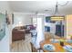 Comfortable living room features a large sofa, slider to the patio, and an adjacent dining area at 773 Artesia Ave, The Villages, FL 32162