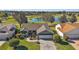 Aerial of home featuring lush landscaping, paver driveway and nearby serene lake at 776 Alcott Ave, The Villages, FL 32162