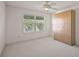 Bright bedroom featuring carpet, ceiling fan, window with blinds, and light wood wardrobe at 776 Alcott Ave, The Villages, FL 32162