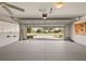 Spacious two-car garage with ample storage, epoxy flooring, and views of the driveway at 776 Alcott Ave, The Villages, FL 32162