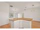 Kitchen island with cabinetry and laminate countertop offers an eat-in bar at 776 Alcott Ave, The Villages, FL 32162