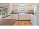 Kitchen features ample cabinet space, white appliances, and view to the outside at 776 Alcott Ave, The Villages, FL 32162
