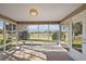 Sunroom featuring tile flooring and golf course views at 776 Alcott Ave, The Villages, FL 32162