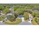 An aerial view of the property showcasing its location within a lush, wooded neighborhood near a lake at 804 Deep Wood Ct, Fruitland Park, FL 34731