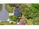 Aerial view of a home with lush trees and landscaping showing the roof and surrounding neighborhood at 804 Deep Wood Ct, Fruitland Park, FL 34731