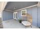 Covered back patio with a wicker chair, view of the French doors, and privacy at 804 Deep Wood Ct, Fruitland Park, FL 34731