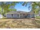 A spacious backyard with a covered patio area, perfect for outdoor entertaining and relaxation at 804 Deep Wood Ct, Fruitland Park, FL 34731