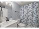 Clean, well-lit bathroom featuring a vanity, toilet, and shower with a stylish blue floral curtain at 804 Deep Wood Ct, Fruitland Park, FL 34731