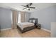 Cozy bedroom featuring neutral paint, natural light, and a comfortable bed setup for rest and relaxation at 804 Deep Wood Ct, Fruitland Park, FL 34731