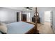 A bedroom showcases a dark wood four-poster bed and dresser, complemented by light wood floors and soft blue walls at 804 Deep Wood Ct, Fruitland Park, FL 34731