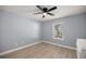 This bedroom has wood floor, a window with blinds, neutral paint, and ample space to unwind at 804 Deep Wood Ct, Fruitland Park, FL 34731