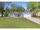 Well-kept single-story home featuring green lawn, fresh landscaping, and a paved driveway at 804 Deep Wood Ct, Fruitland Park, FL 34731