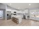 Well-lit kitchen featuring stainless steel appliances, white cabinetry, and an island with seating at 804 Deep Wood Ct, Fruitland Park, FL 34731