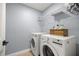 Laundry room showcasing a modern washer and dryer set, complete with shelving and ample storage space at 804 Deep Wood Ct, Fruitland Park, FL 34731