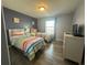 Bright bedroom features two twin beds, a window, and a white dresser at 8973 Cat Palm Rd, Kissimmee, FL 34747