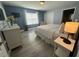 Comfortable bedroom features a large window, updated floors, closet, and a dresser with a vase at 8973 Cat Palm Rd, Kissimmee, FL 34747