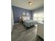 Bright bedroom with blue accent wall, bedside tables, and patterned bedding at 8973 Cat Palm Rd, Kissimmee, FL 34747
