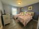 Bright bedroom featuring two twin beds, a window and a dresser with a TV at 8973 Cat Palm Rd, Kissimmee, FL 34747