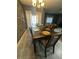 Chic dining room with wood table, seating for six, modern decor, and gray vinyl flooring at 8973 Cat Palm Rd, Kissimmee, FL 34747